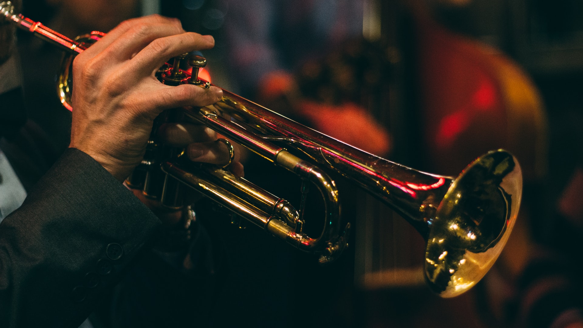 a trumpet being played in dim lighting