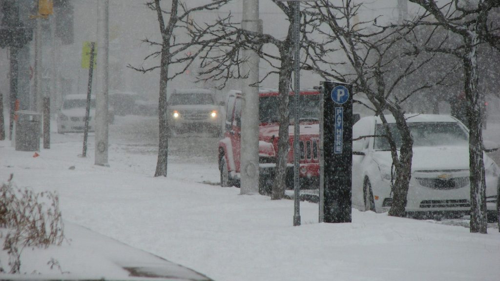 Cars driving during in snow.