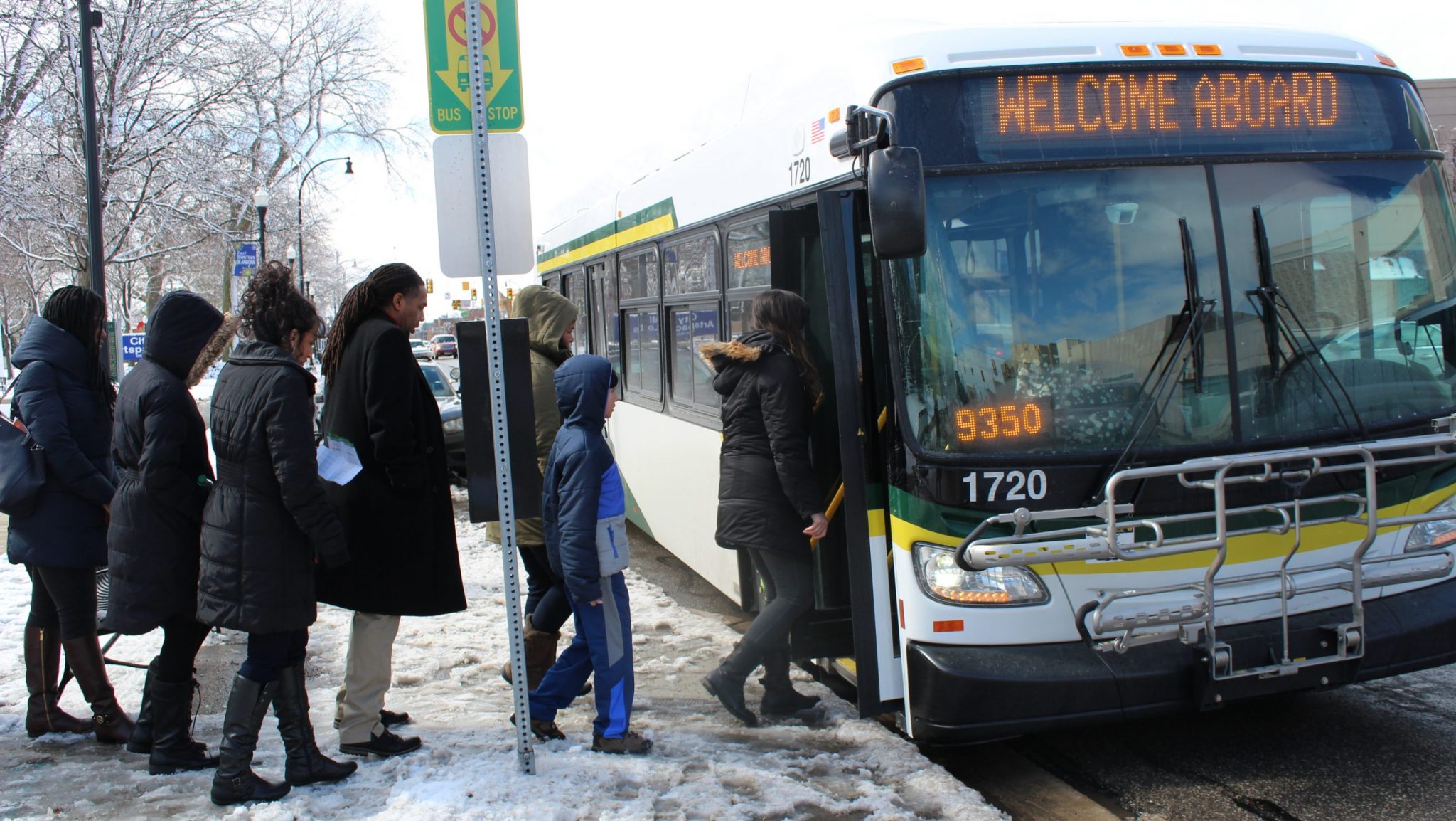 People getting on a DDOT bus.