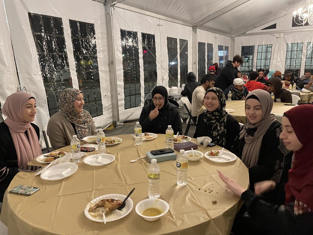 Eman Sarker sits with volunteers (second from left) pic 2