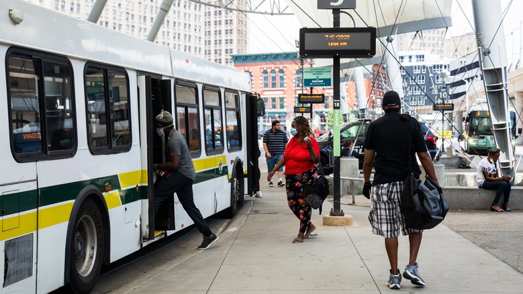 ddot passengers with masks getting on bus