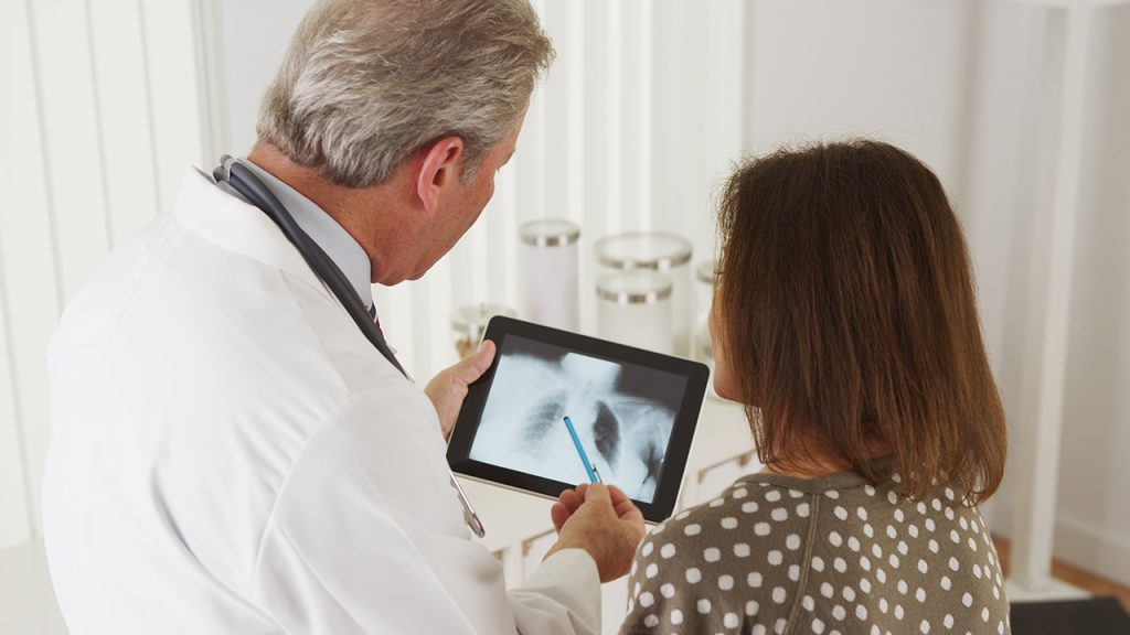 Doctor Talking To Elderly Woman Patient