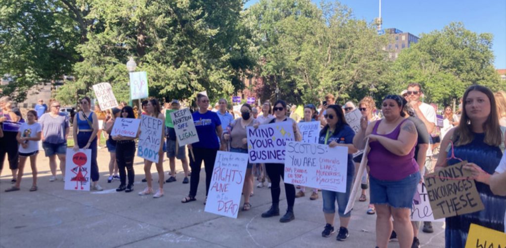 Demonstrators hold up signs in support of abortion rights