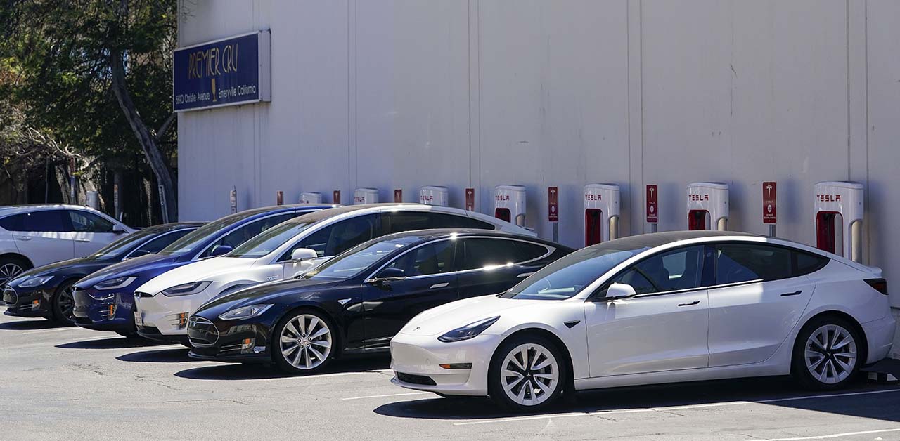 Electric vehicles can be seen charging at a shopping center in Emeryville, Calif., Wednesday, Aug. 10, 2022.