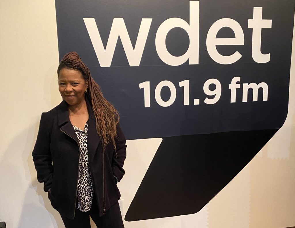 musician Patrice Rushen smiles in front of the WDET logo in our live studio