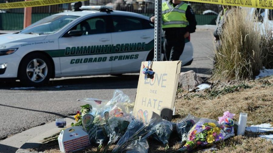 Flowers and a sign reading "love over hate" lay near a gay nightclub in Colorado Springs, Colo., Sunday, Nov. 20, 2022 where a shooting occurred late Saturday night.