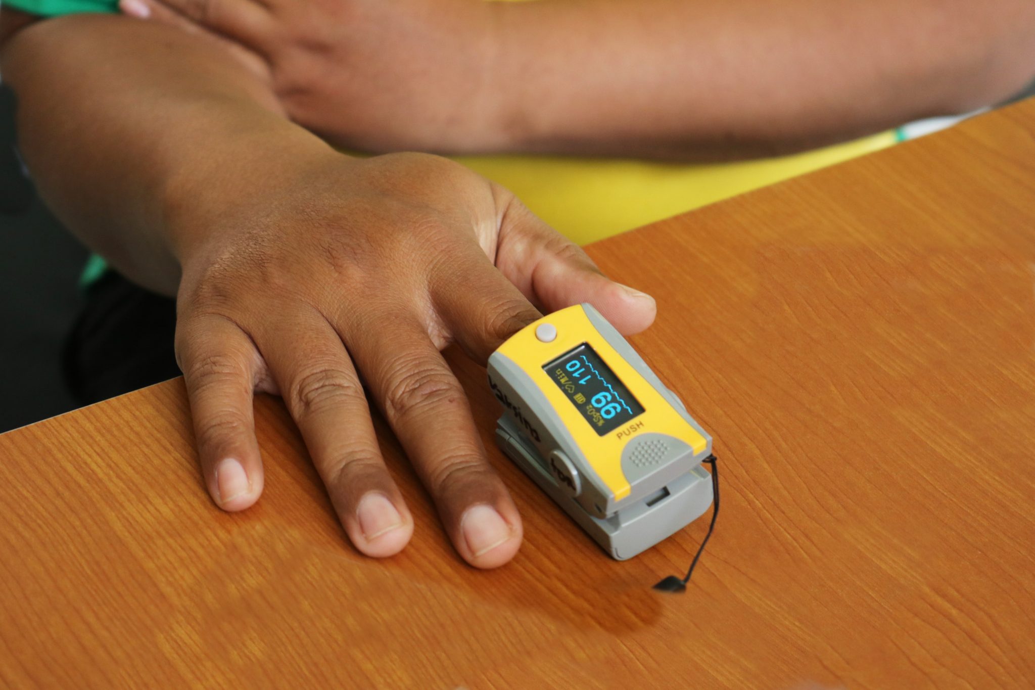 Pulse oximeter on someone's right index finger.