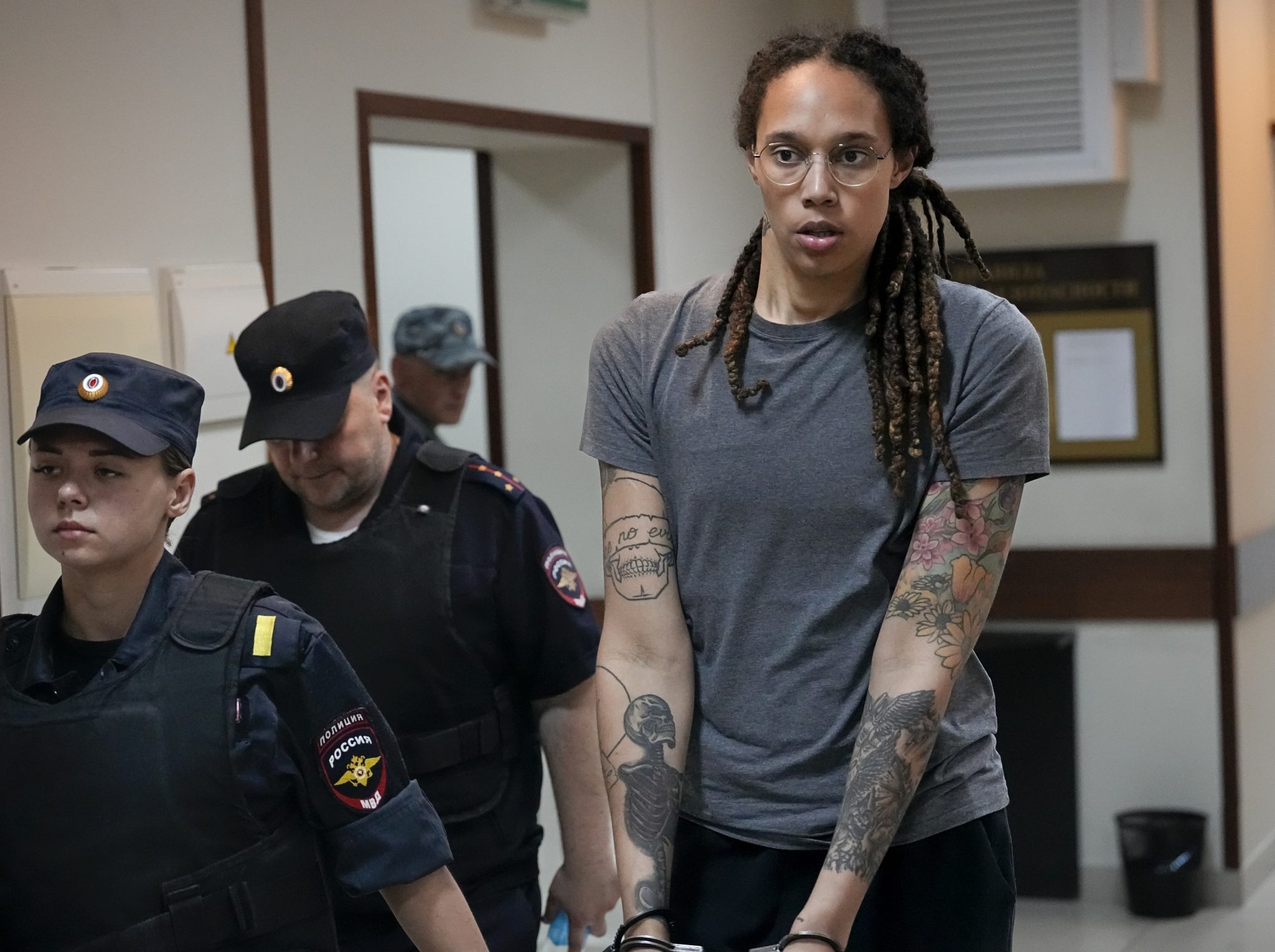 WNBA star and two-time Olympic gold medalist Brittney Griner is escorted from a courtroom after a hearing in Khimki just outside Moscow, Russia, on Aug. 4, 2022.