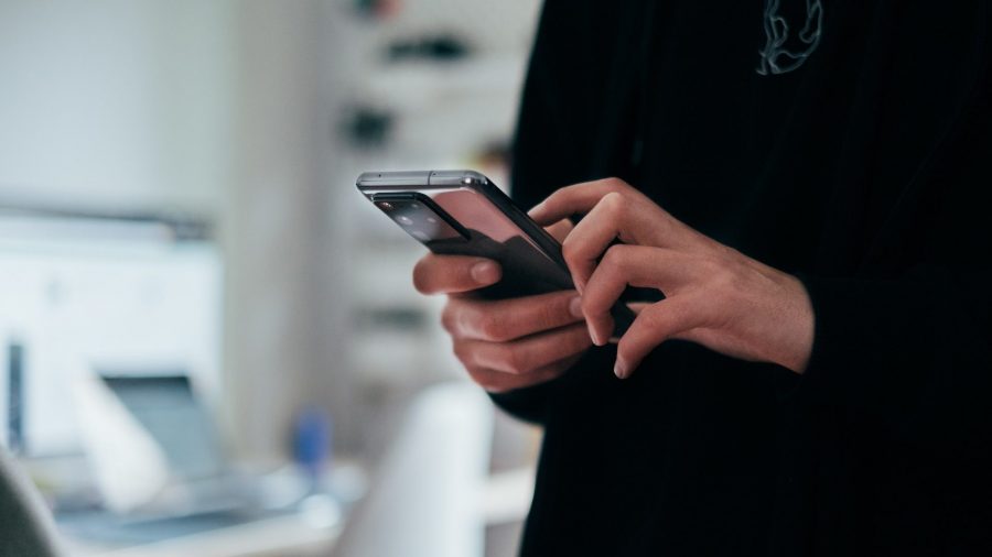 a person scrolls on a smartphone