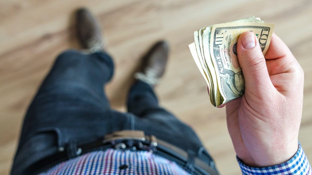 Stock photo of person holding money.