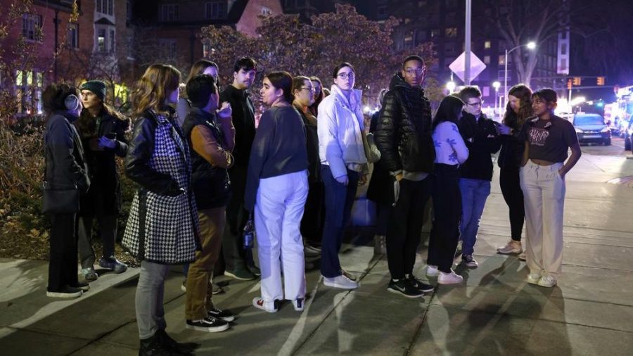 Students gather on the campus of Michigan State University after a shelter in place order was lifted early Tuesday, Feb. 14, 2023, in East Lansing, Mich. A gunman opened fire Monday night at Michigan State University, killing three people and wounding five more, before fatally shooting himself after an hours-long manhunt that forced frightened students to hide in the dark.