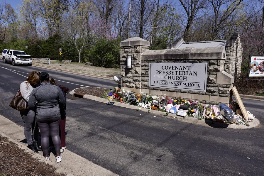 A group of women pray at a memorial at the entrance to The Covenant School on Wednesday, March 29, 2023, in Nashville, Tenn.