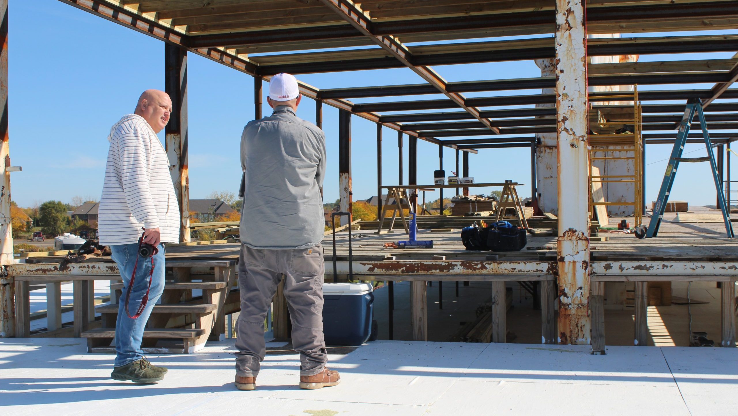 Ed Van Slambrouck (left) and Stephen Faraj on the third deck of the boat. The wood above them will be the new fourth floor.