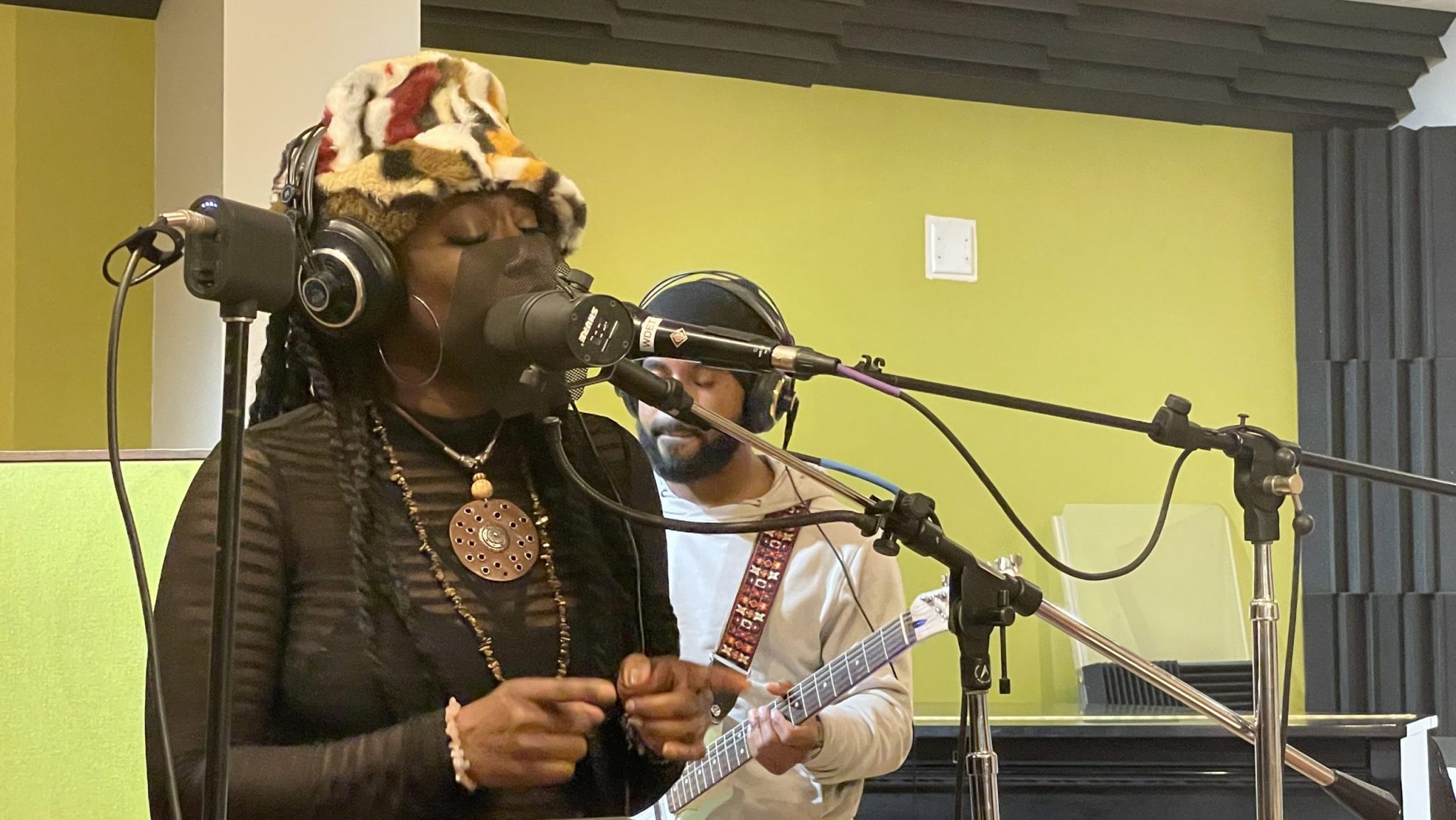 Ideeyah sings into a microphone in WDET's Studio A