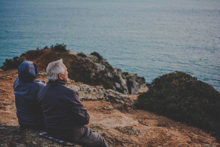 A senior couple looking out at the ocean.
