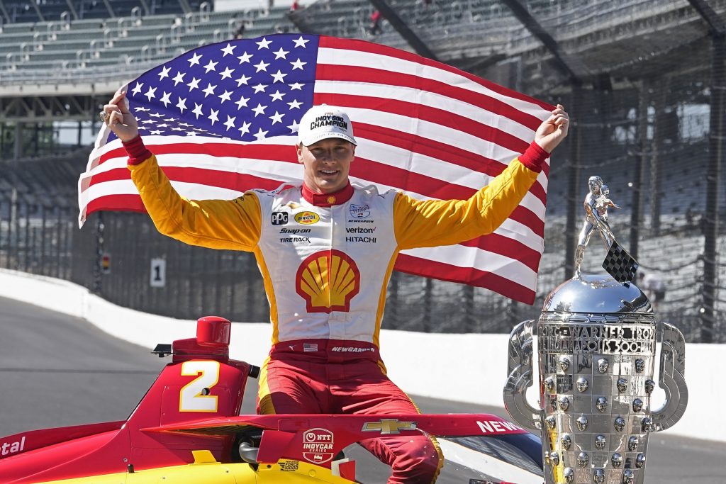 Josef Newgarden poses with the Borg-Warner Trophy during the traditional winners photo session at Indianapolis Motor Speedway, Monday, May 29, 2023, in Indianapolis.