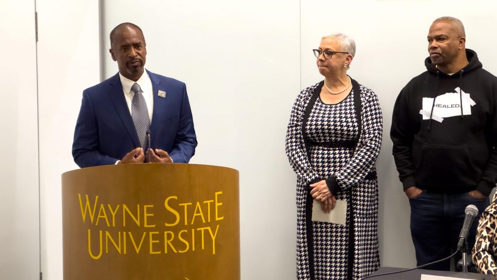 Scott Benson stands at a Wayne State podium