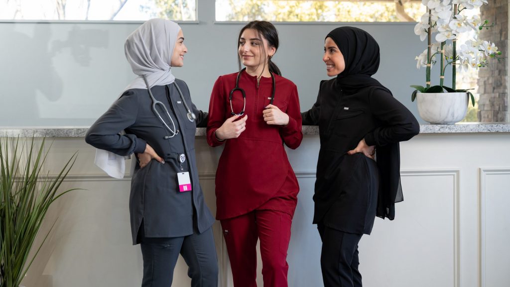 Photo of nurses posing in scrubs.