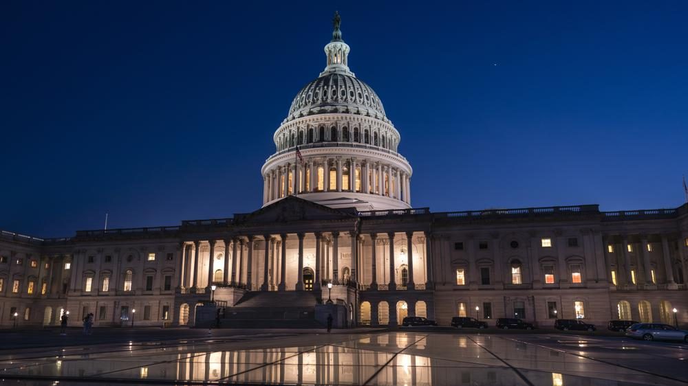 Days away from a default crisis, the Capitol is illuminated as the Senate works into the night to finish votes on amendments on the big debt ceiling and budget cuts package, at the Capitol in Washington, Thursday evening, June 1, 2023.