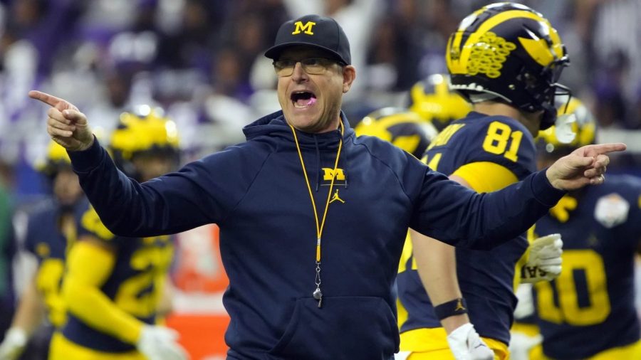 FILE - Michigan head coach Jim Harbaugh gestures during the first half of the Fiesta Bowl NCAA college football semifinal playoff game against TCU, Saturday, Dec. 31, 2022, in Glendale, Ariz.