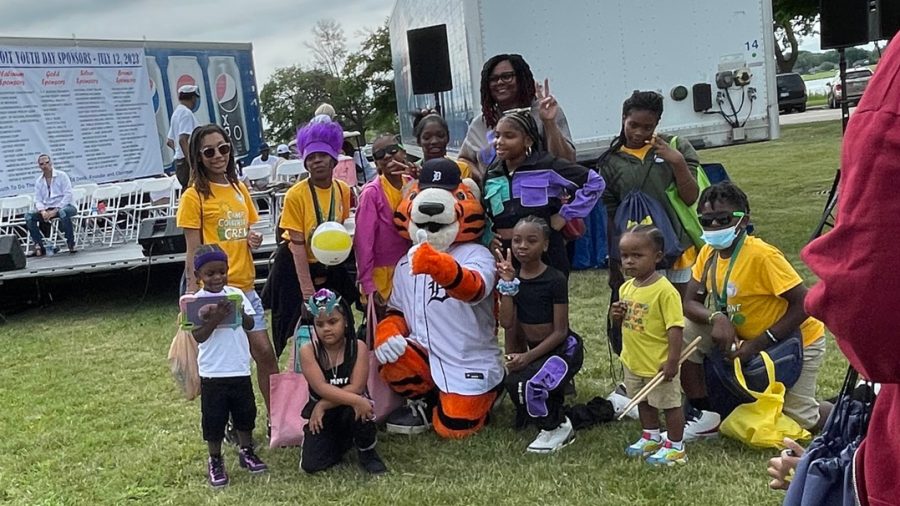 Children gather around Detroit Tigers mascot Paws to pose for a photo Metro Detroit Youth Day on July 12, 2023, on Belle Isle.