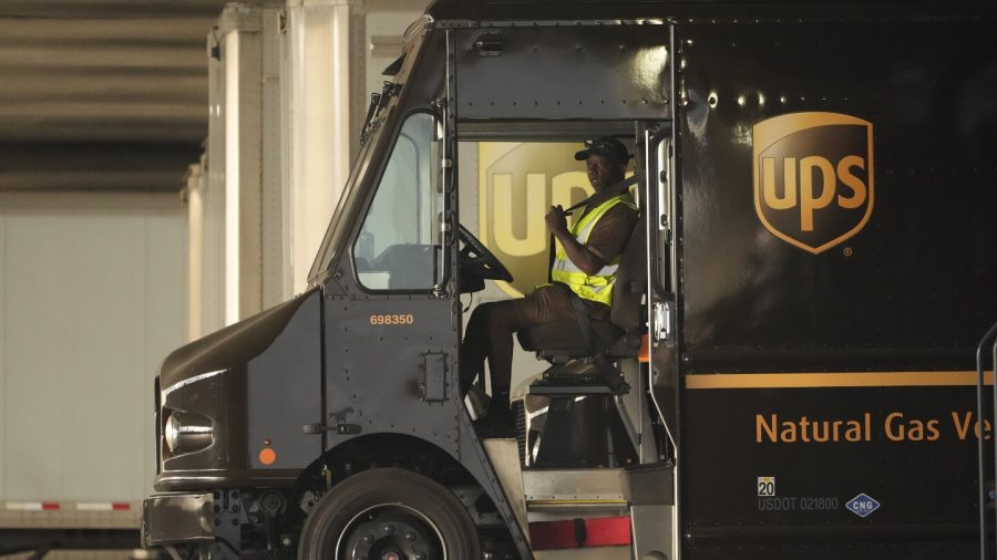 FILE - A UPS driver puts his seat belt on before driving off as UPS workers hold a rally in downtown Los Angeles as a national strike deadline nears on Wednesday, July 19, 2023.