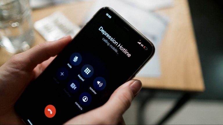 Photo of smartphone dialing crisis hotline.