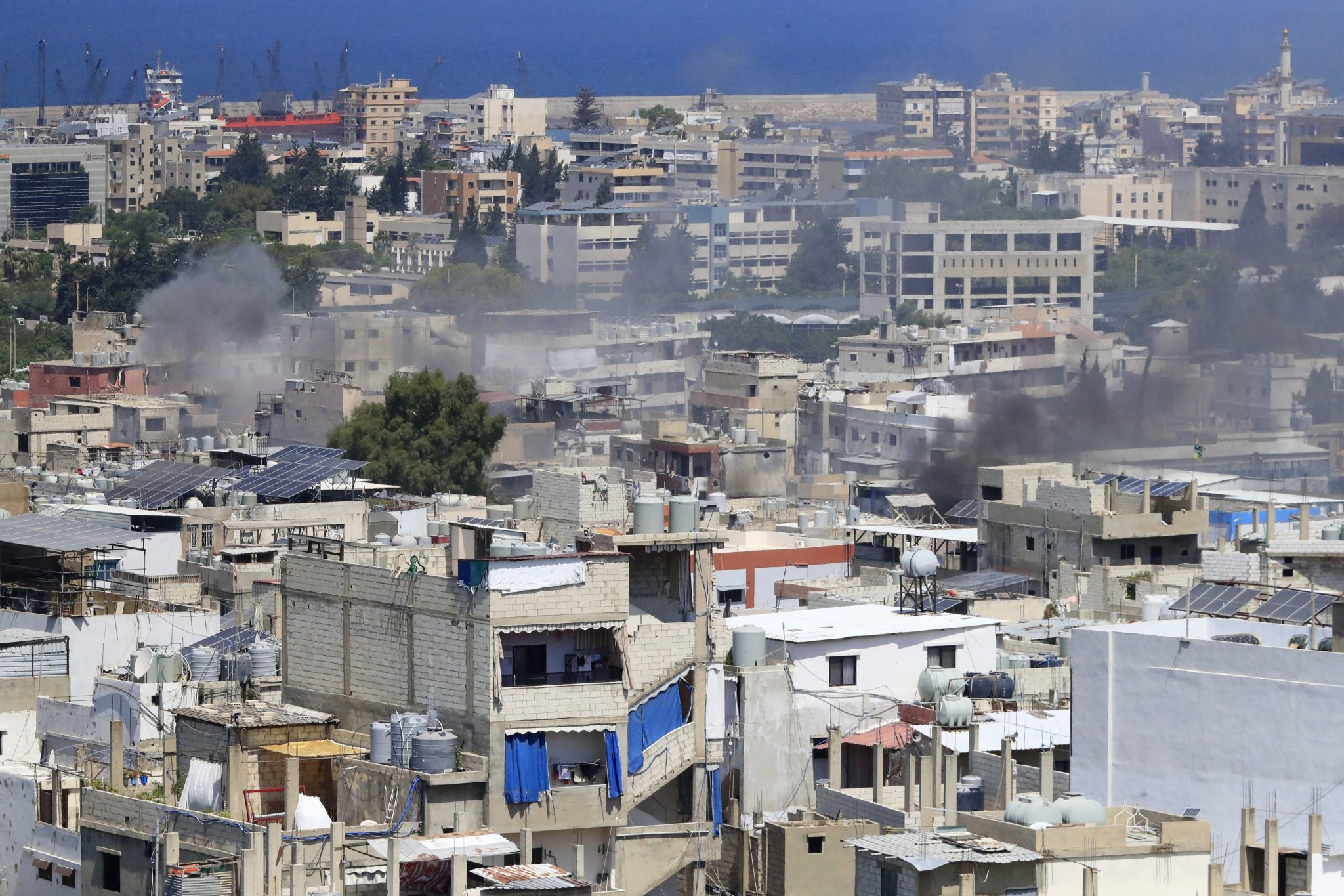 FILE - Smoke rises during a third day of clashes that erupted between members of the Palestinian Fatah group and Islamist factions in the Palestinian refugee camp of Ein el-Hilweh near the southern port city of Sidon, Lebanon, on July 31, 2023.