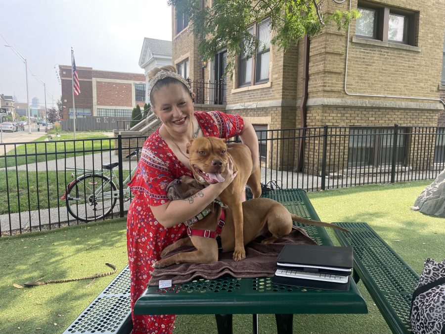 Rebecca Lyke posing with her two dogs at the Midtown Dog Park in Detroit, Mich.