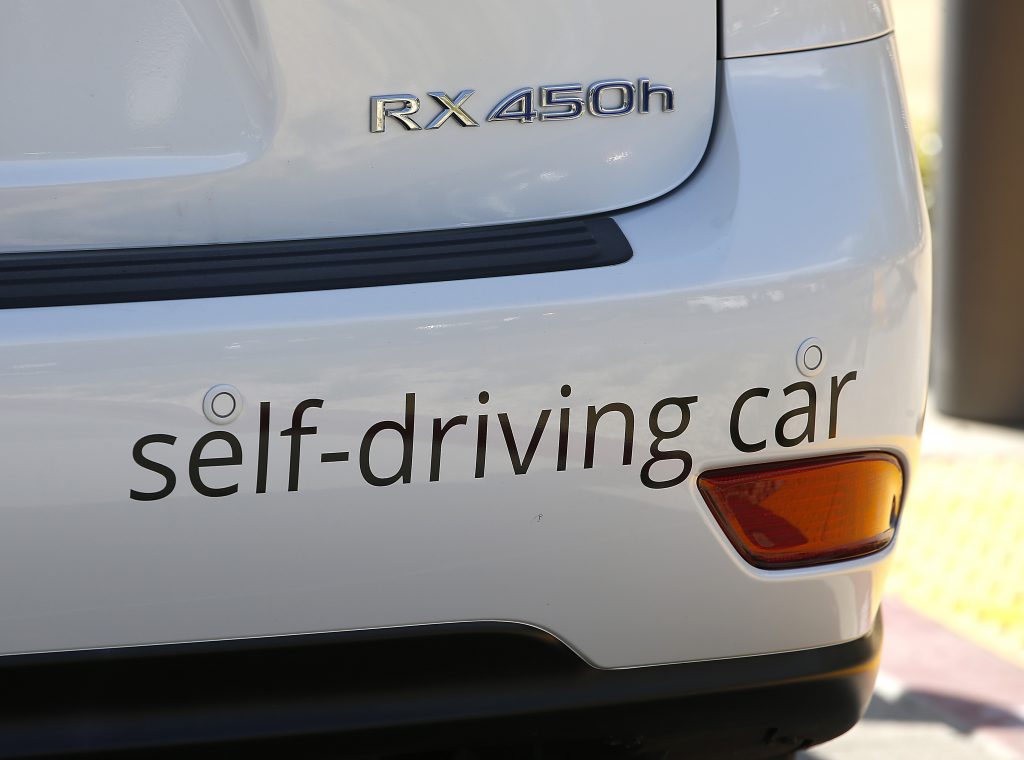 FILE - Google's self-driving Lexus car drives along street during a demonstration at Google campus on May 13, 2015, in Mountain View, Calif.