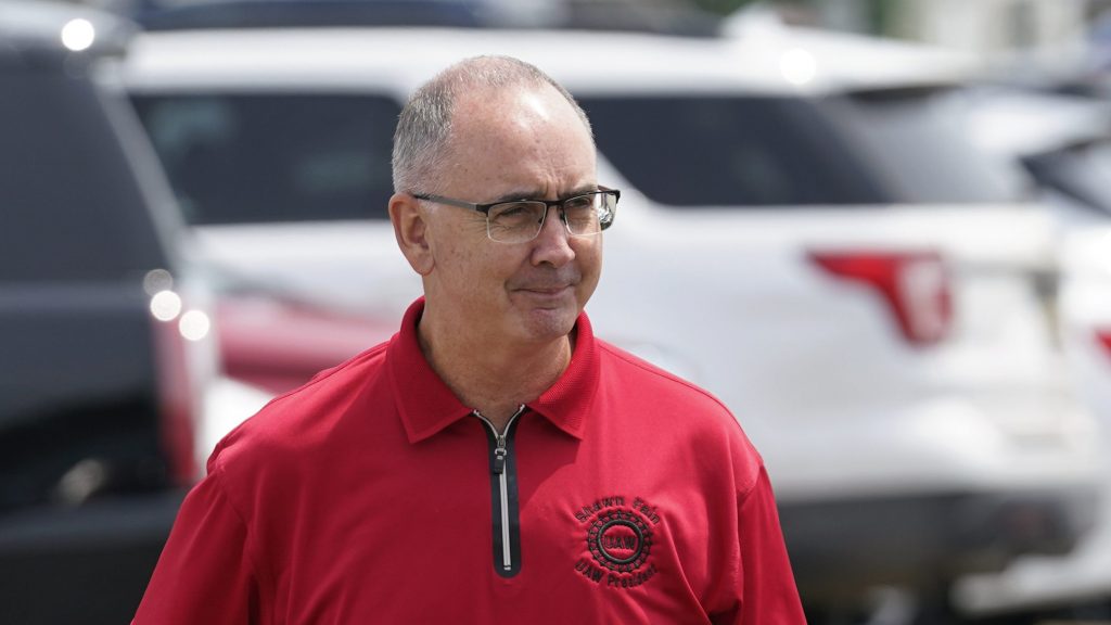 FILE - United Auto Workers president Shawn Fain talks with autoworkers outside the General Motors Factory Zero plant in Hamtramck, Mich., July 12, 2023.