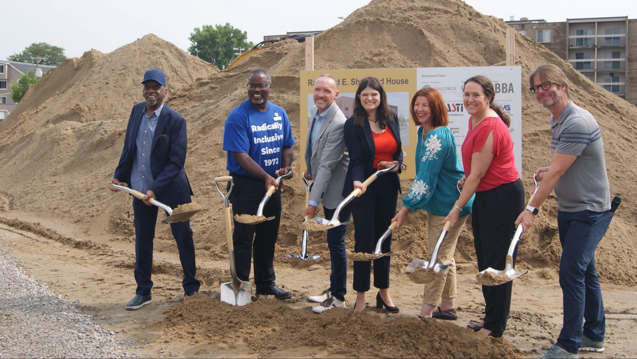 Speakers at the Shepherd House groundbreaking ceremony pose for a photo op.