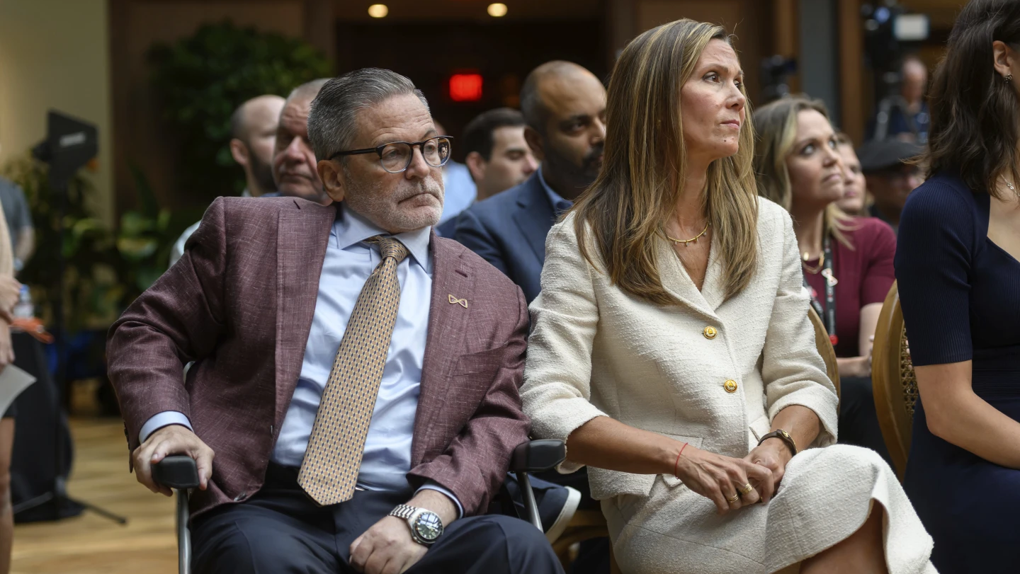 Dan and Jennifer Gilbert sit in the audience during a press conference at the Book Tower in Detroit, Wednesday, Sept. 6, 2023, to announce a nearly $375 million philanthropic effort to fight strokes and research cures for neurofibromatosis.