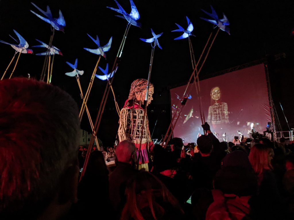 Little Amal among puppet birds in Castlefield Bowl, Manchester.