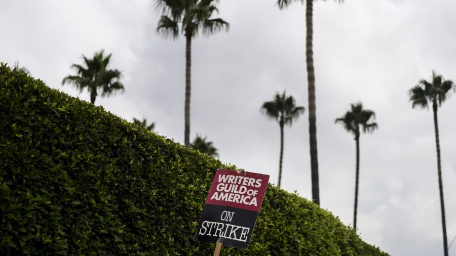 FILE - A demonstrator holds up a sign during a rally outside the Paramount Pictures Studio in Los Angeles, Thursday, Sept. 21, 2023.