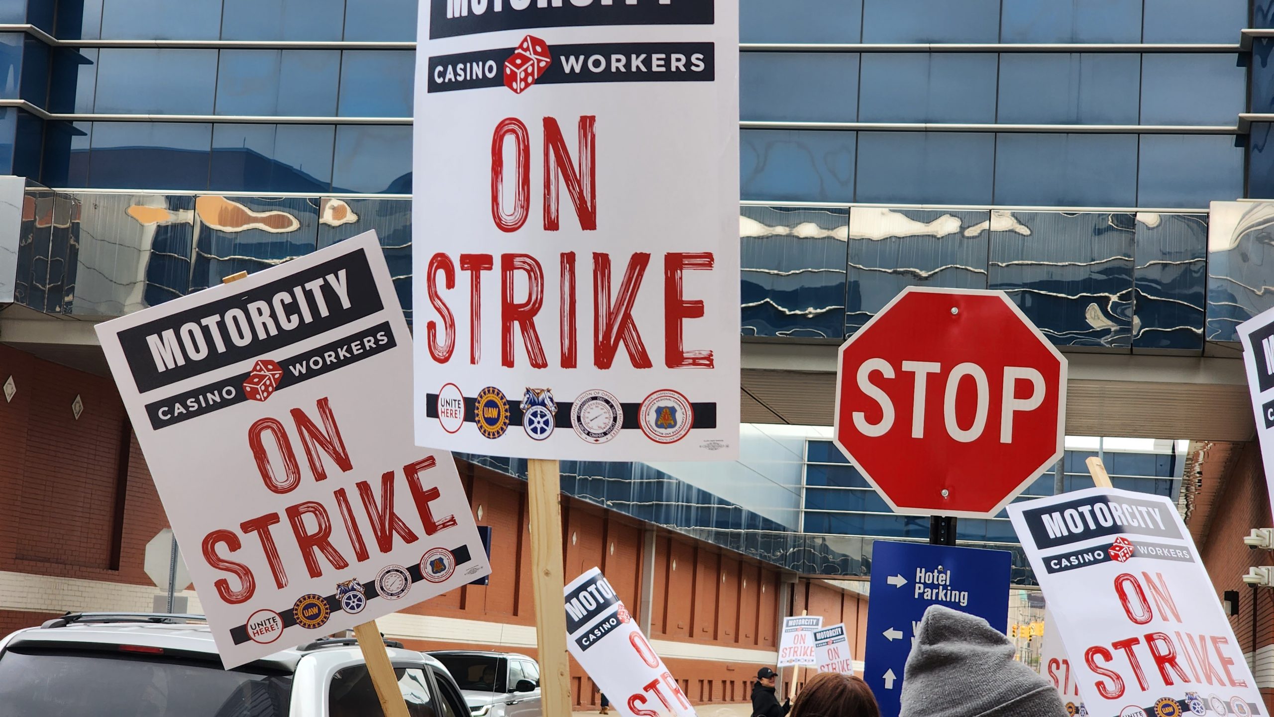 Demonstrating workers wave their signs in the air.