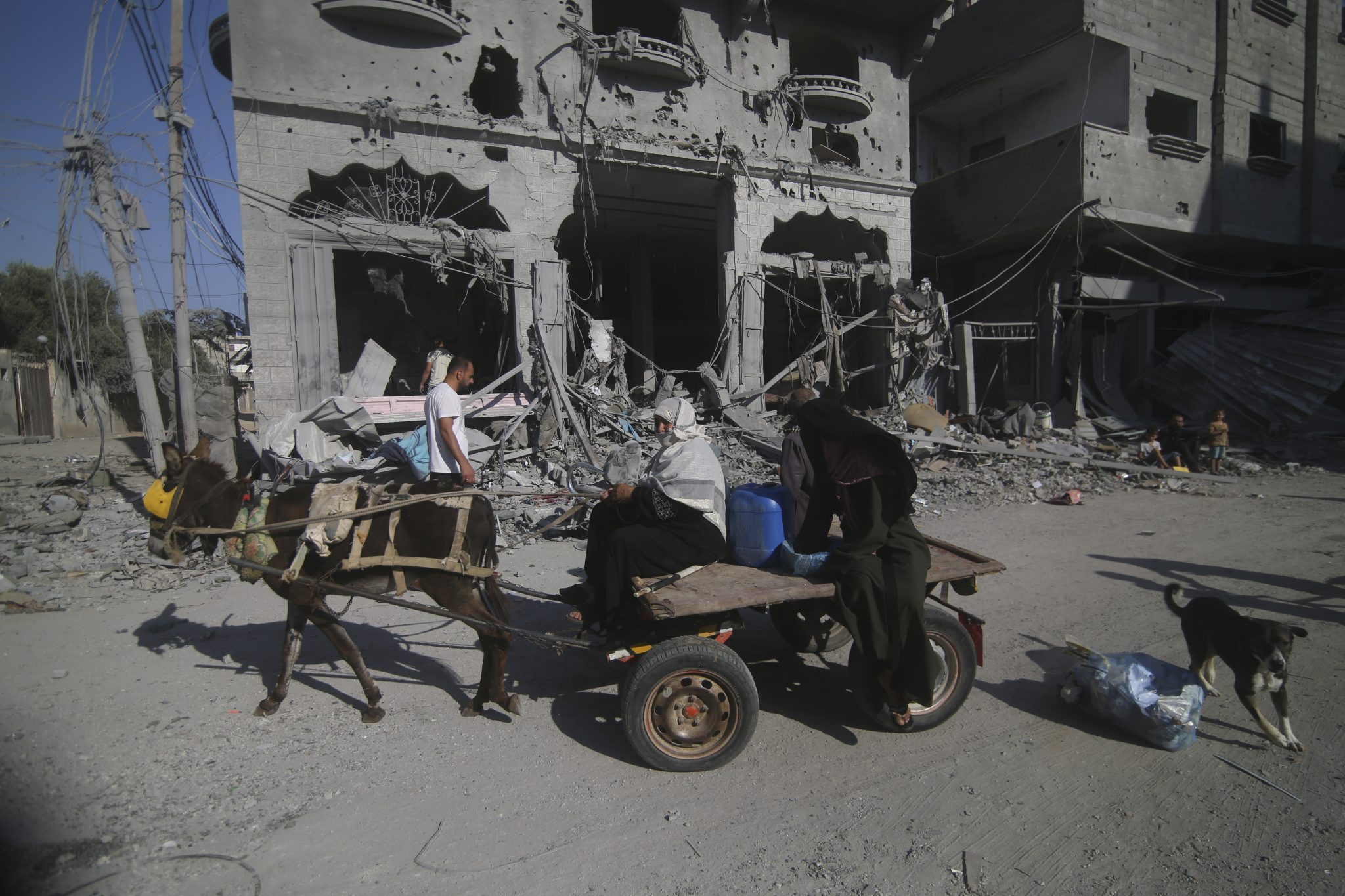 Palestinians leave their houses following Israeli airstrikes in Rafah refugee camp, southern Gaza Strip, Thursday, Oct. 12, 2023.