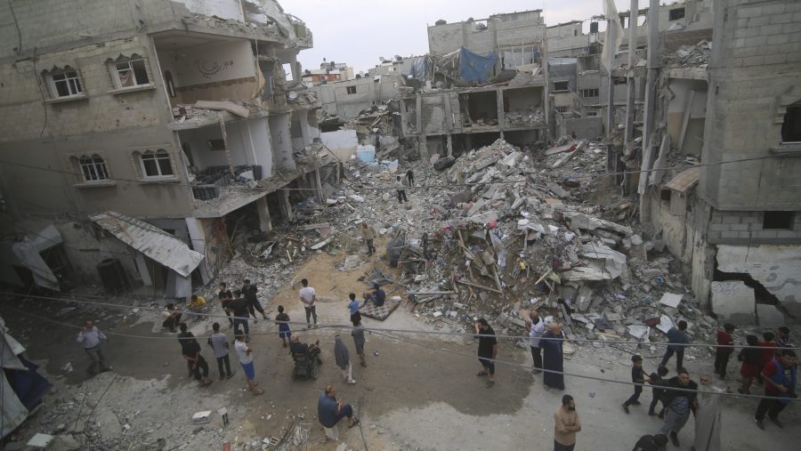 Palestinians inspect the rubble at a refugee camp in Rafah, Gaza Strip, after an Israeli air strike killed dozens of people, Monday, Oct. 9, 2023.
