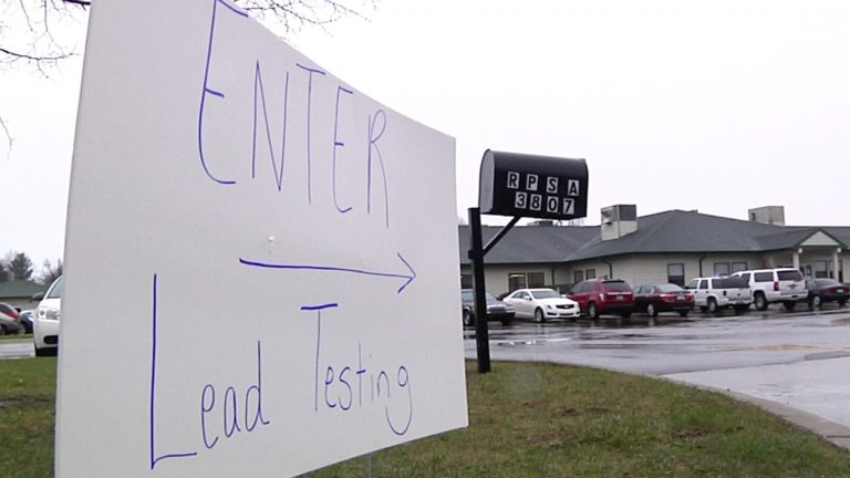 This Thursday, March 24, 2016, image from video shows a hand-written sign placed at the entrance to a lead-testing clinic in Flint, Mich.