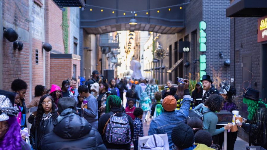 A crowd of trick-or-treaters walks through Parker's Alley in Detroit