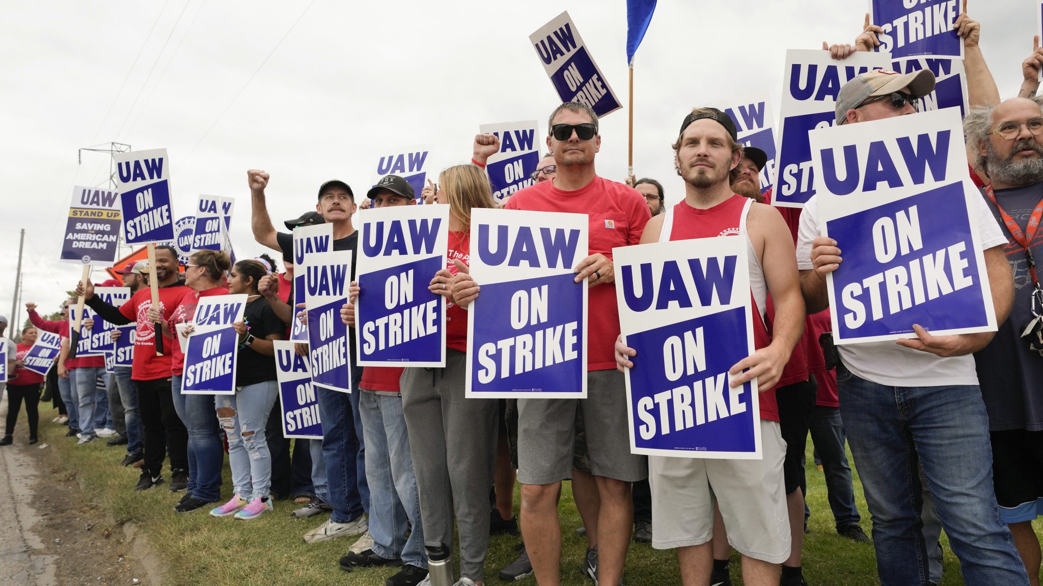 United Auto Workers members hold picket signs near a General Motors Assembly Plant in Delta Township, Mich., Friday, Sept. 29, 2023.