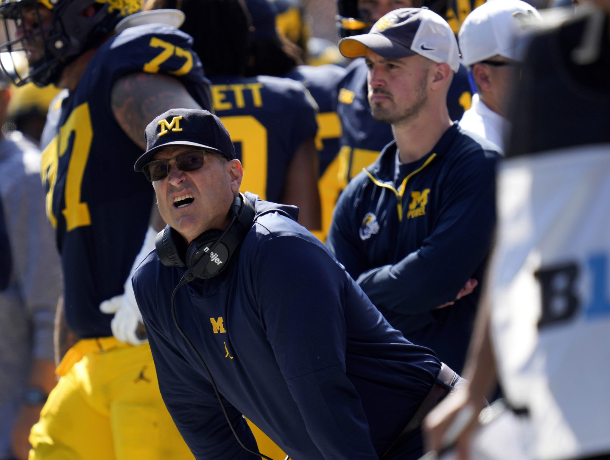 Michigan head coach Jim Harbaugh, front left, watches against Rutgers as analytics assistant Connor Stalions, right, looks on during an NCAA college football game in Ann Arbor, Mich., Sept. 23, 2023.