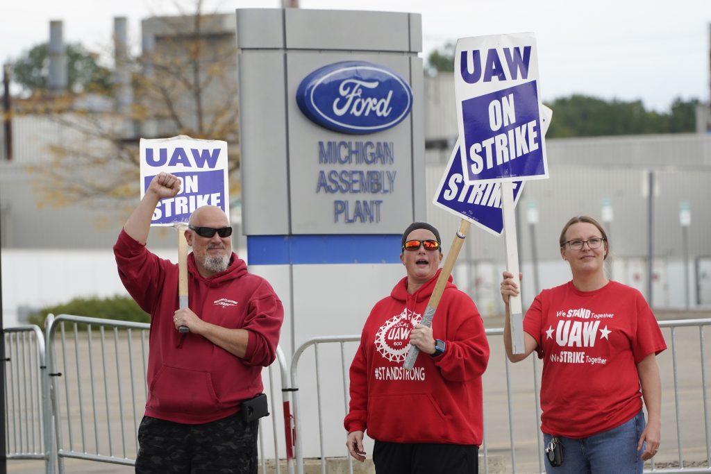 FILE - United Auto Workers members walk the picket line at the Ford Michigan Assembly Plant in Wayne, Mich., Sept. 26, 2023.