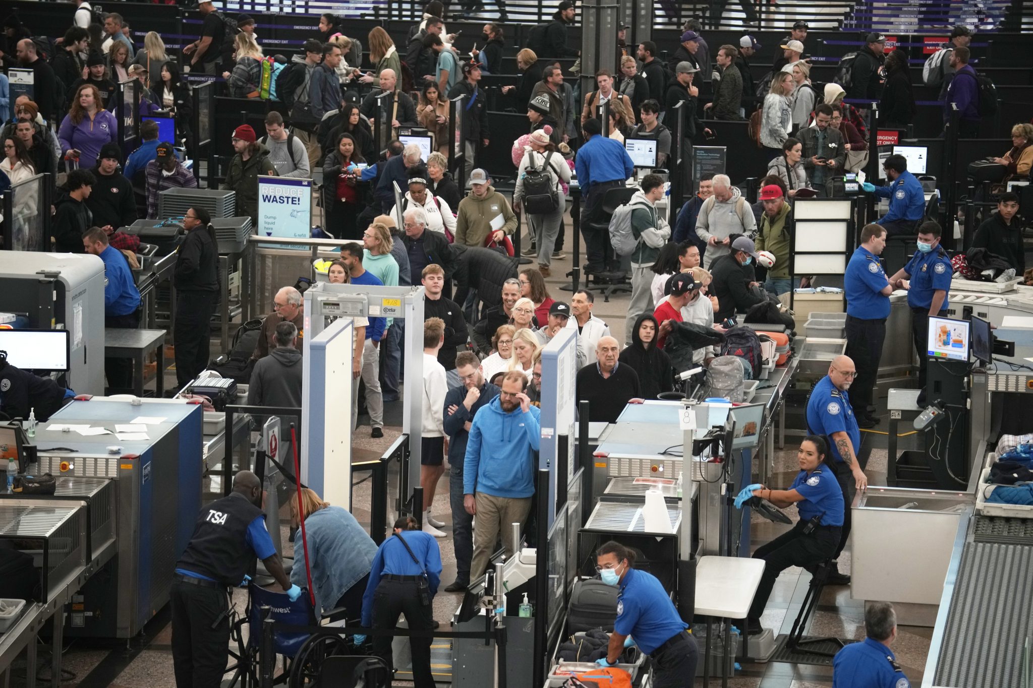 Travellers queue up to pass through the south security checkpoint at Denver International Airport, Monday, Nov. 20, 2023, in Denver.