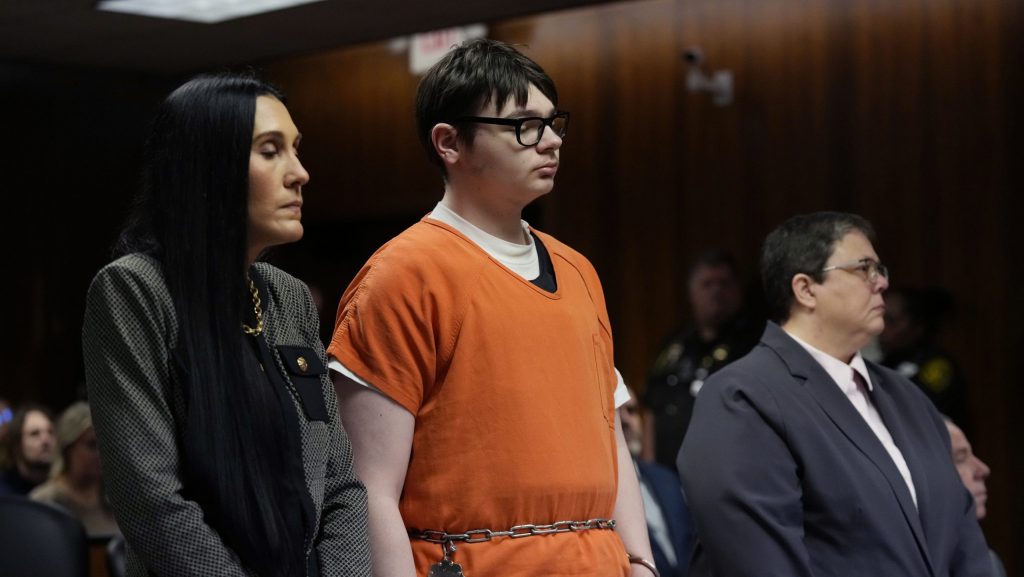 Ethan Crumbley stands with his attorneys Paulette Loftin, left, and Amy Hopp, Friday, Dec. 8, 2023, in Pontiac, Mich.