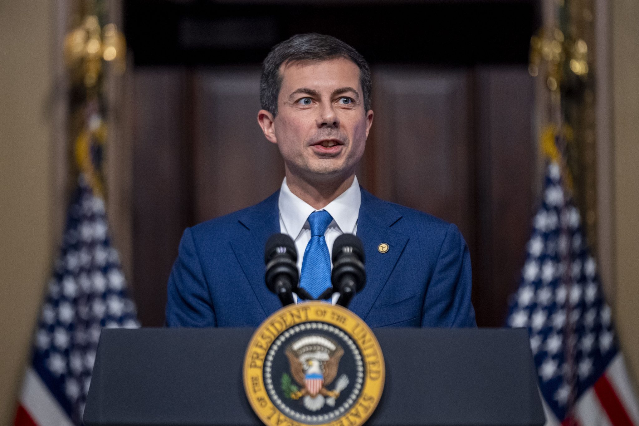 Transportation Secretary Pete Buttigieg, accompanied by President Joe Biden, speaks about supply chain issues in the Indian Treaty Room on the White House complex in Washington, Monday, Nov. 27, 2023.