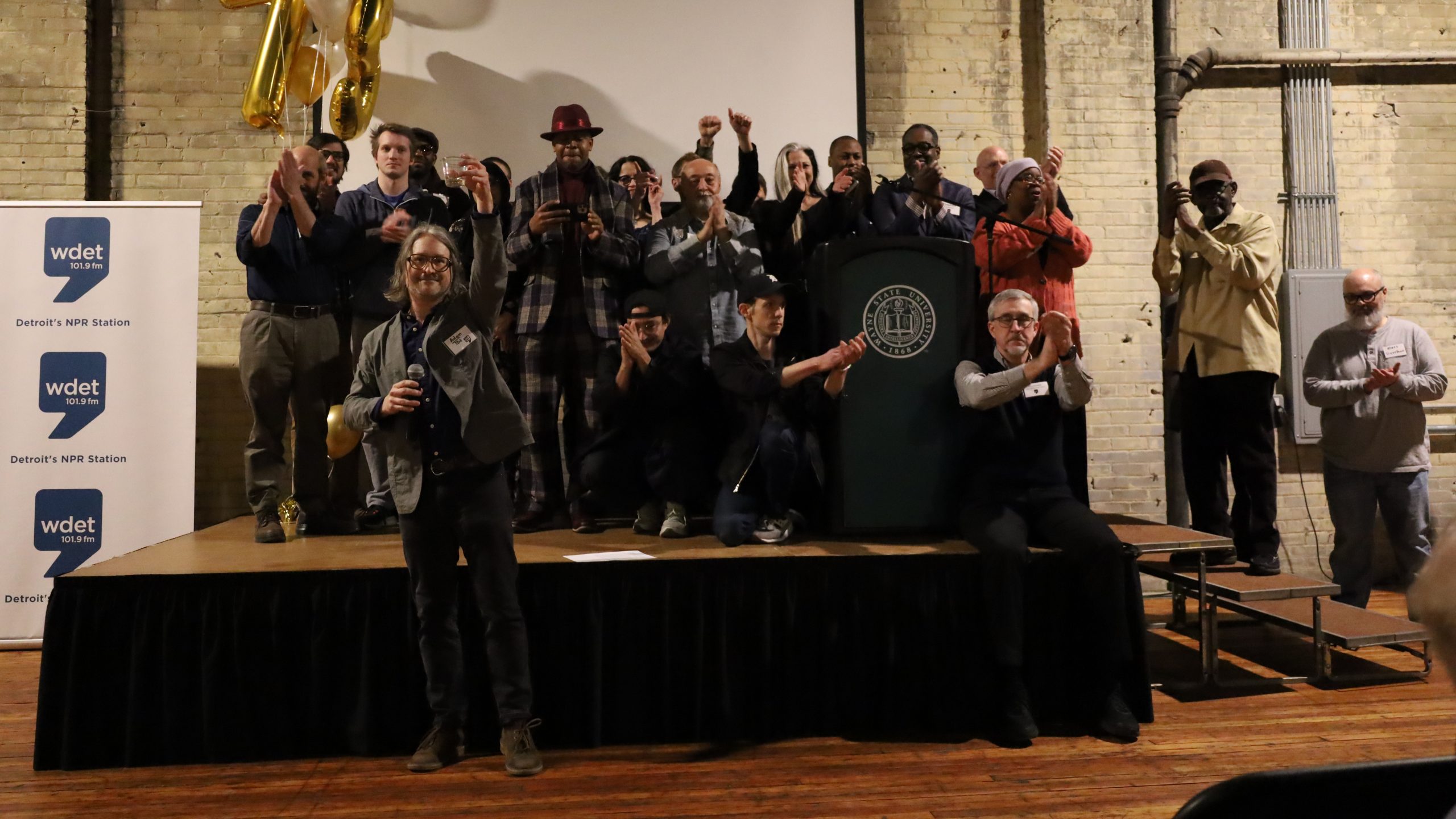 WDET staff stand on stage at the Jam Handy.