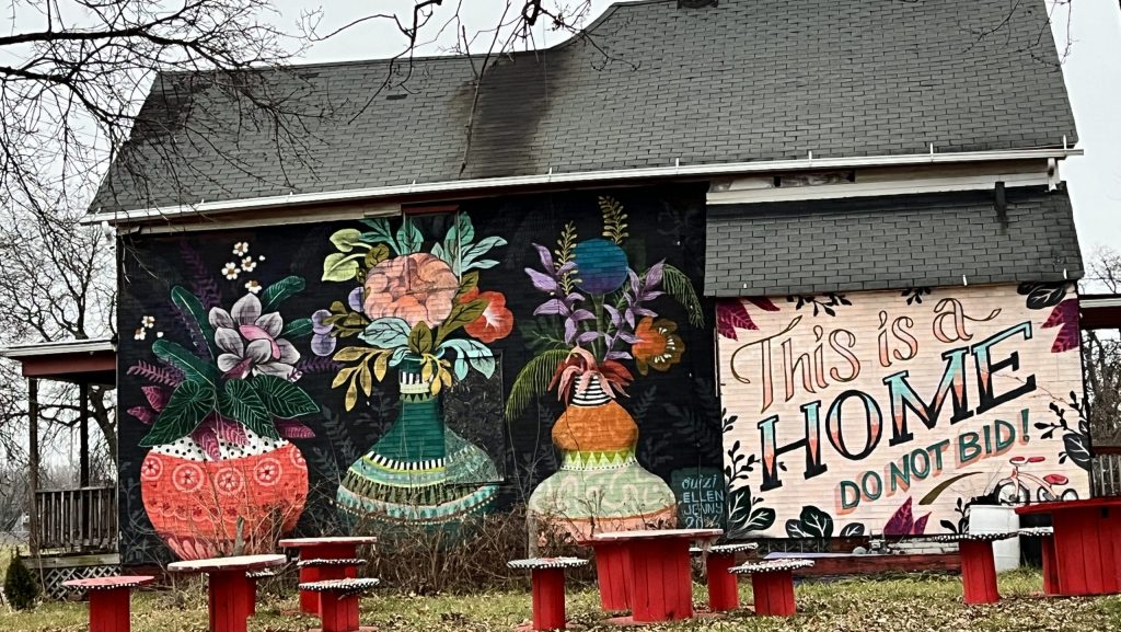 A house in Detroit with the words "This is a home. Do not bid." spray painted onto it.