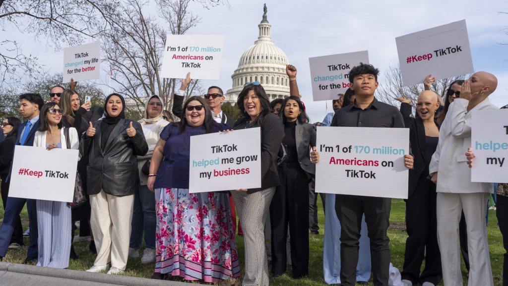 Devotees of TikTok cheer their support to passing motorists at the Capitol in Washington, before the House passed a bill that would lead to a nationwide ban of the popular video app if its China-based owner doesn't sell, Wednesday, March 13, 2024.