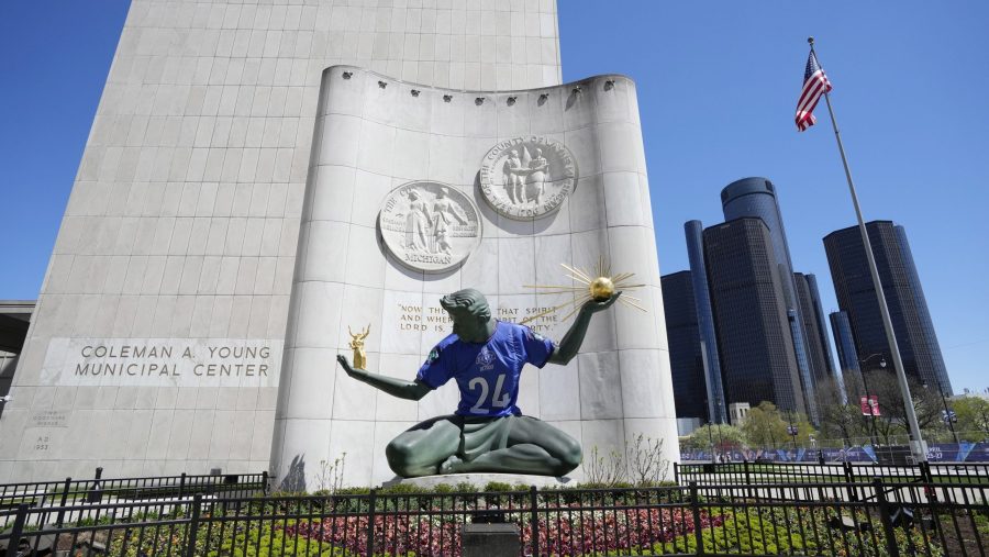 An NFL football draft jersey is displayed on the Spirit of Detroit statue